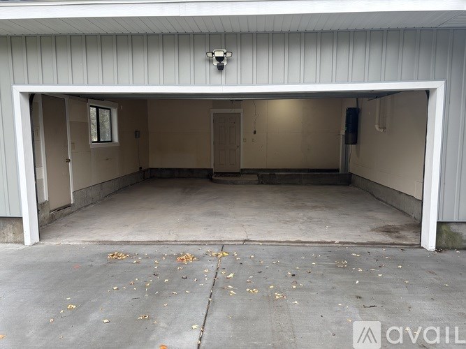 A large empty garage with a white ceiling and walls.