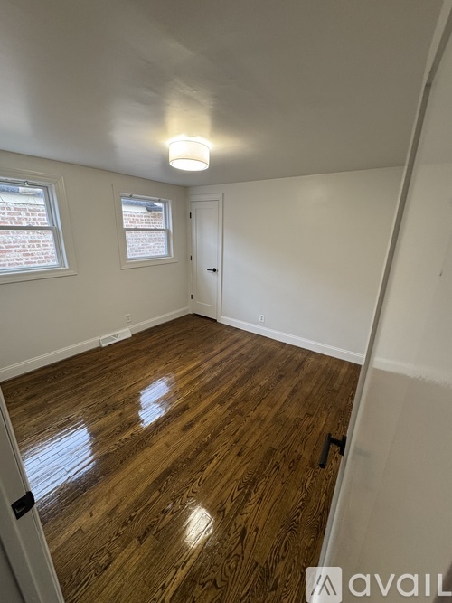 A room with wooden floors and white walls.