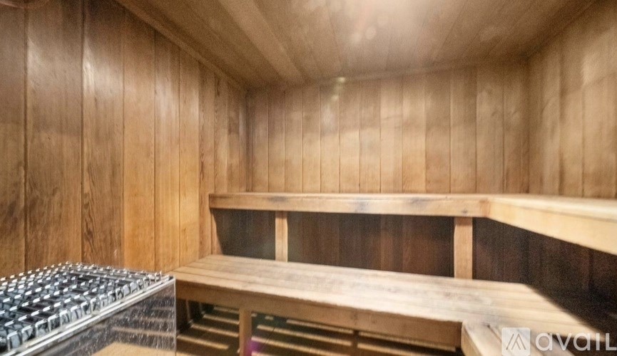 A wooden room with a bench and a keyboard on the left side.