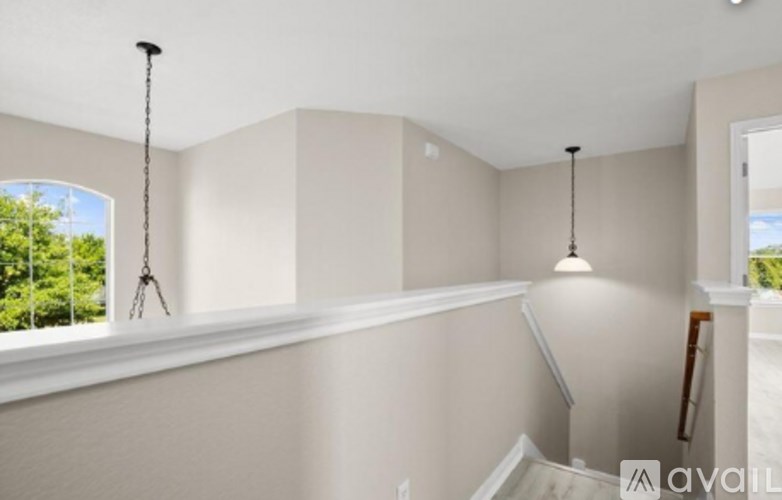 A room with a window and a staircase.