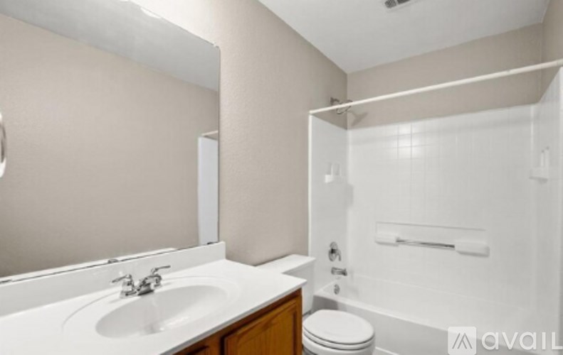 A bathroom with a sink, toilet, and bathtub.