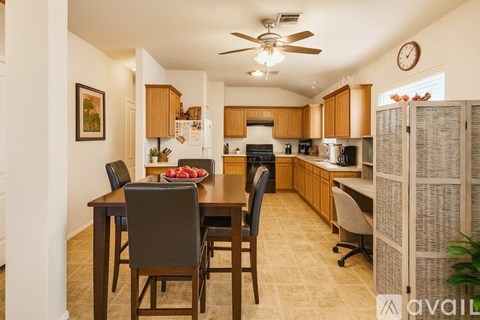 A kitchen with a table and chairs in the middle of the room.