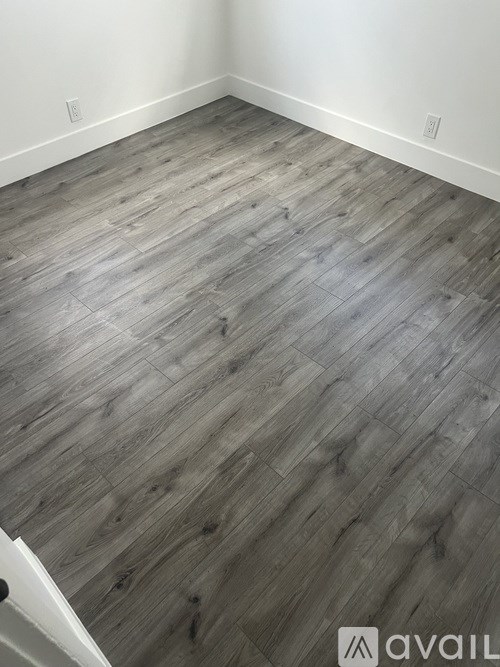 A room with a wooden floor and white walls.