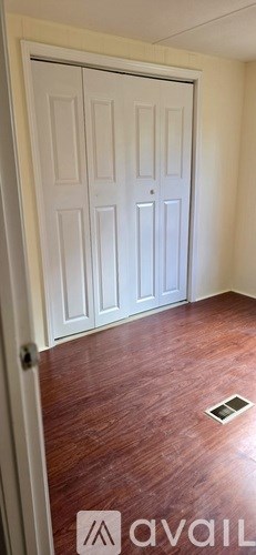 A room with two doors and a wooden floor.