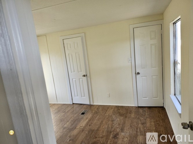 A small bathroom with a white tub and a window with blinds.