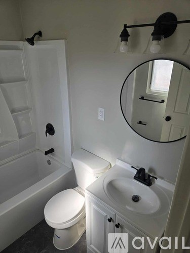 A white toilet sits next to a sink in a bathroom.