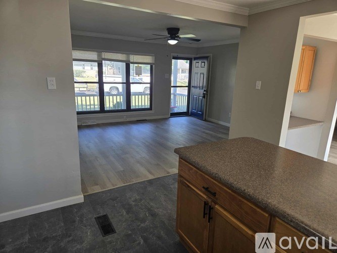 A kitchen with a counter and cabinets is available for rent.