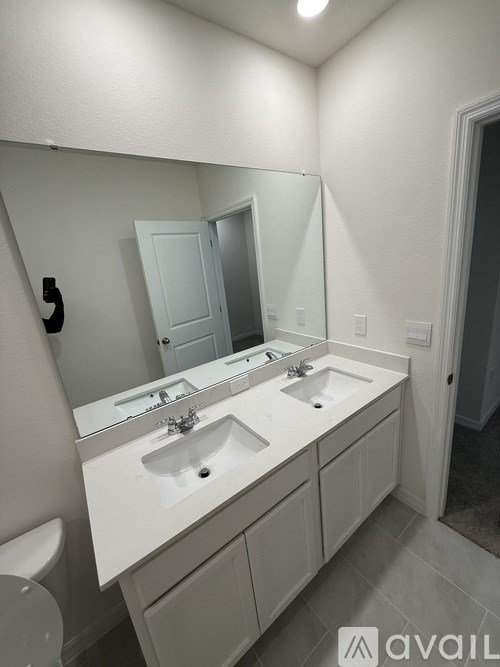 A bathroom with a white sink and mirror.
