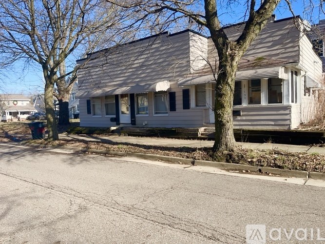 A house with a tree in front of it.