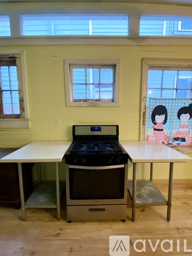 A kitchen with a stove and a table.