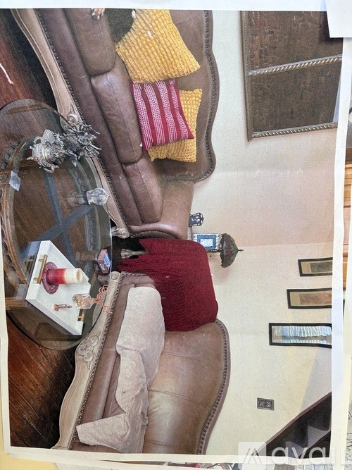 A pile of clothes and a pair of shoes are on a table.