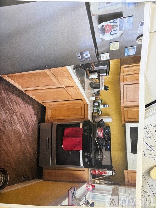 A kitchen with a microwave and oven on top of a counter.