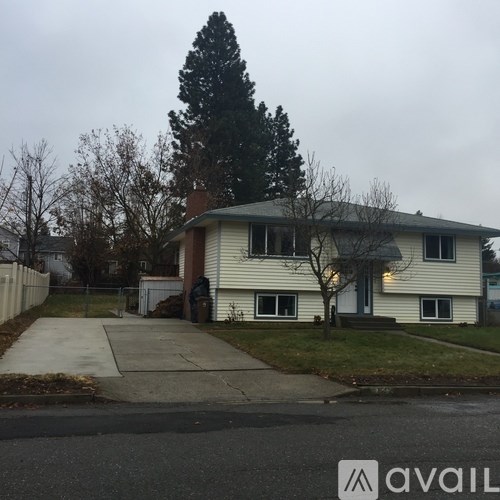 A house with a tree in front of it.