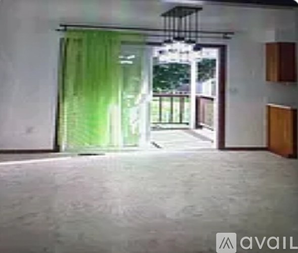 A room with a sliding door leading to a balcony.