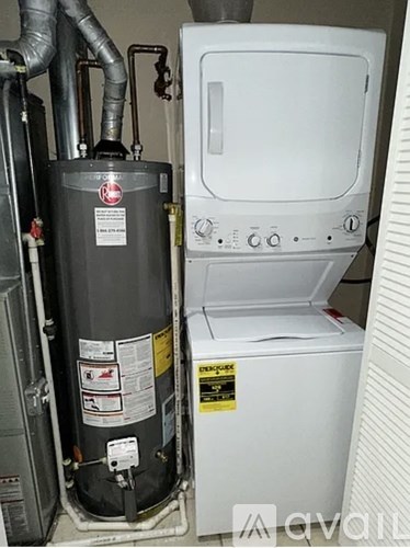 A tankless water heater is installed next to a wall heater.