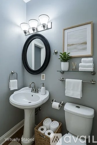 A bathroom with a white sink and toilet.