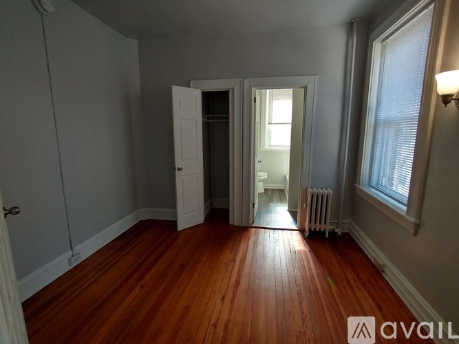 A room with wooden floors and white walls.