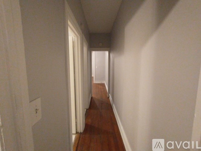 A black door with the number 3E on it.