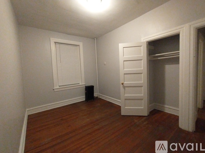 A small bathroom with a toilet and a window.