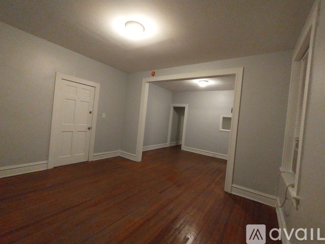 A room with wooden floors and white walls.