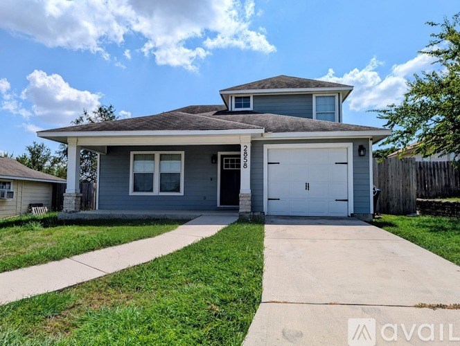 A two-story house with a garage is for sale.