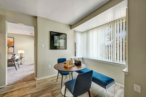 A dining room with a table and chairs.