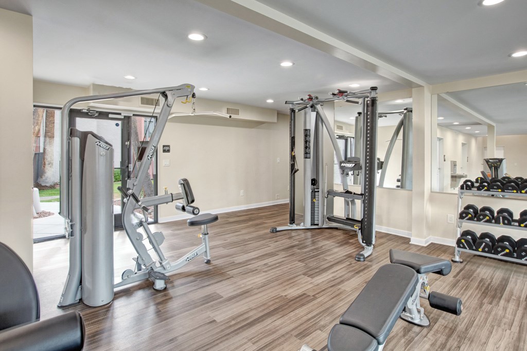 A spacious home gym with a variety of equipment.