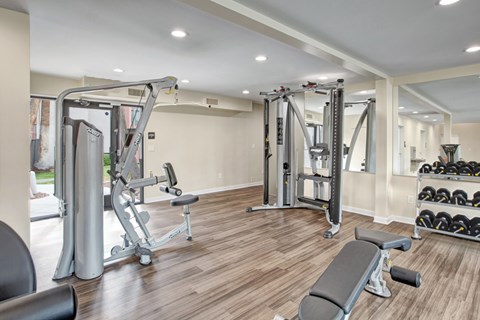A spacious home gym with a variety of equipment.