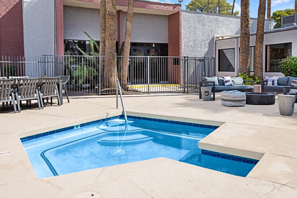 A pool with a fountain in the middle of it.