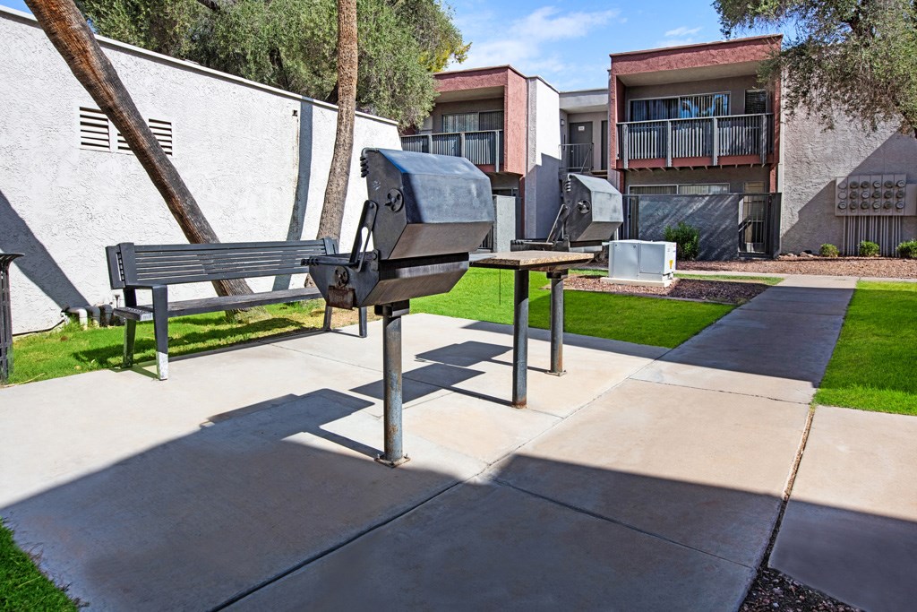A park bench with a backpack on it.