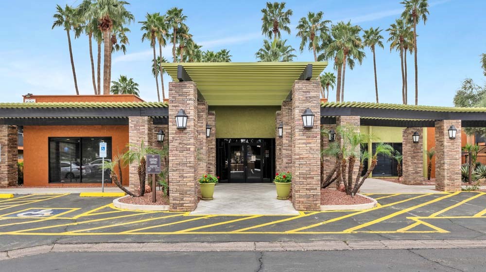 A building with a green roof and a yellow line in front.