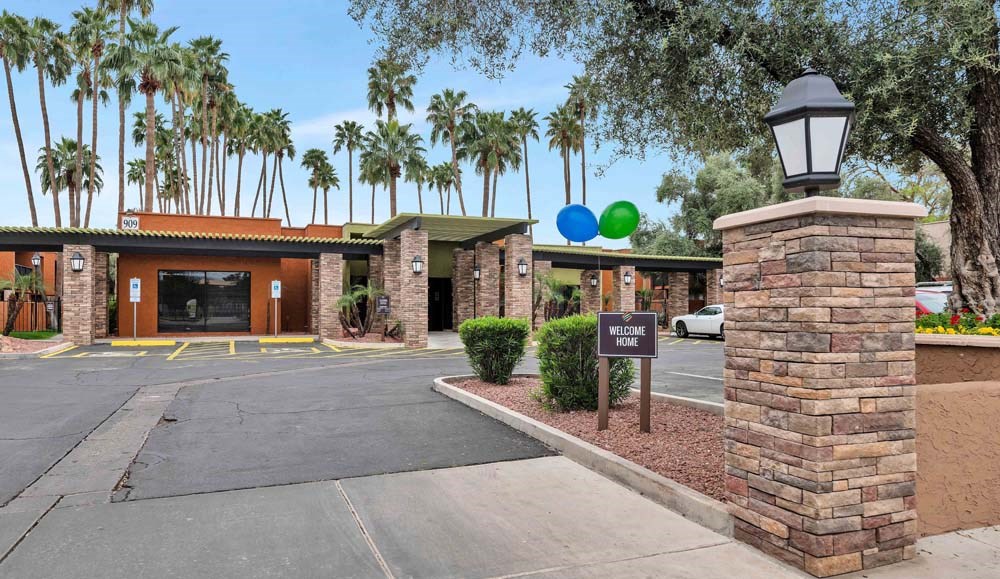 The entrance to a building with a sign that says "Welcome Home".