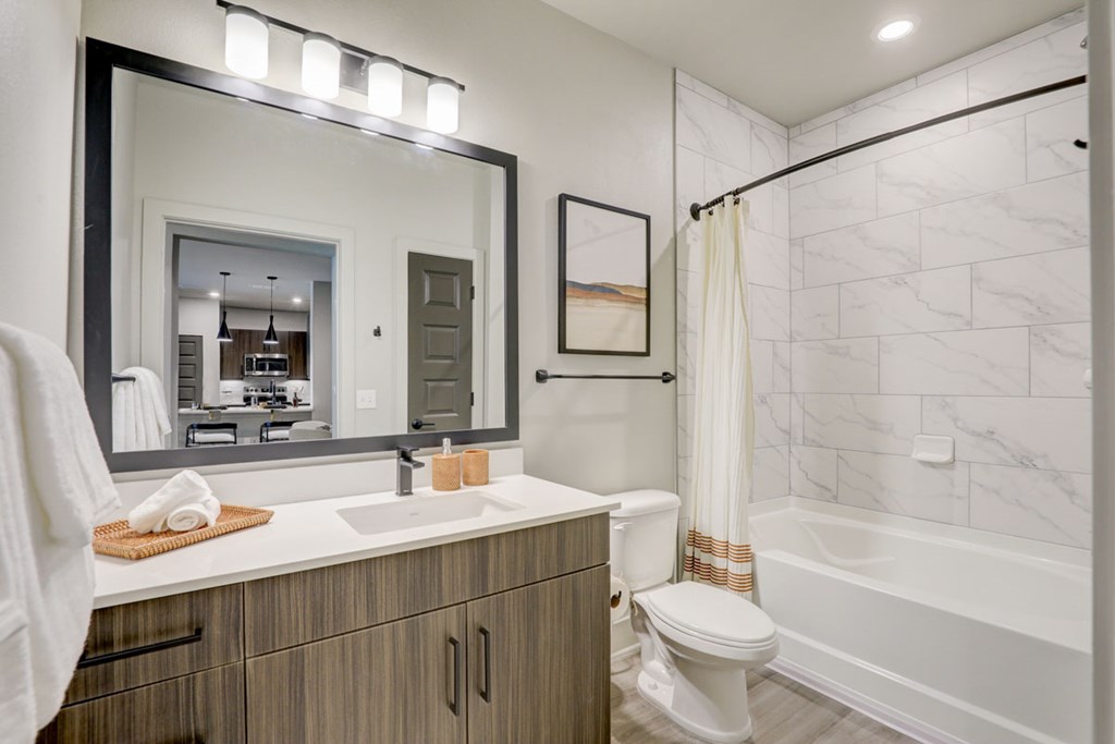 A bathroom with a white toilet and a white sink.