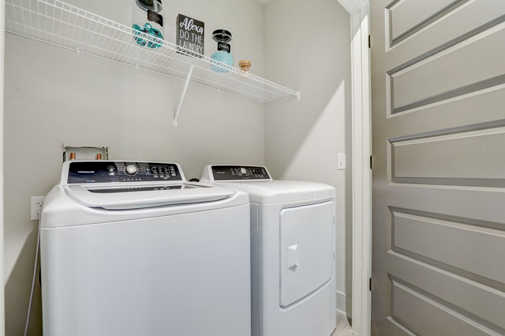 A white washing machine and dryer in a small laundry room.