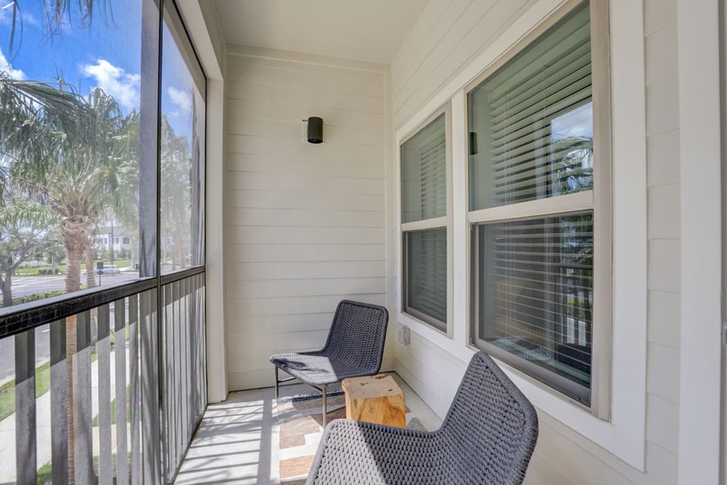 A balcony with a chair and a table.