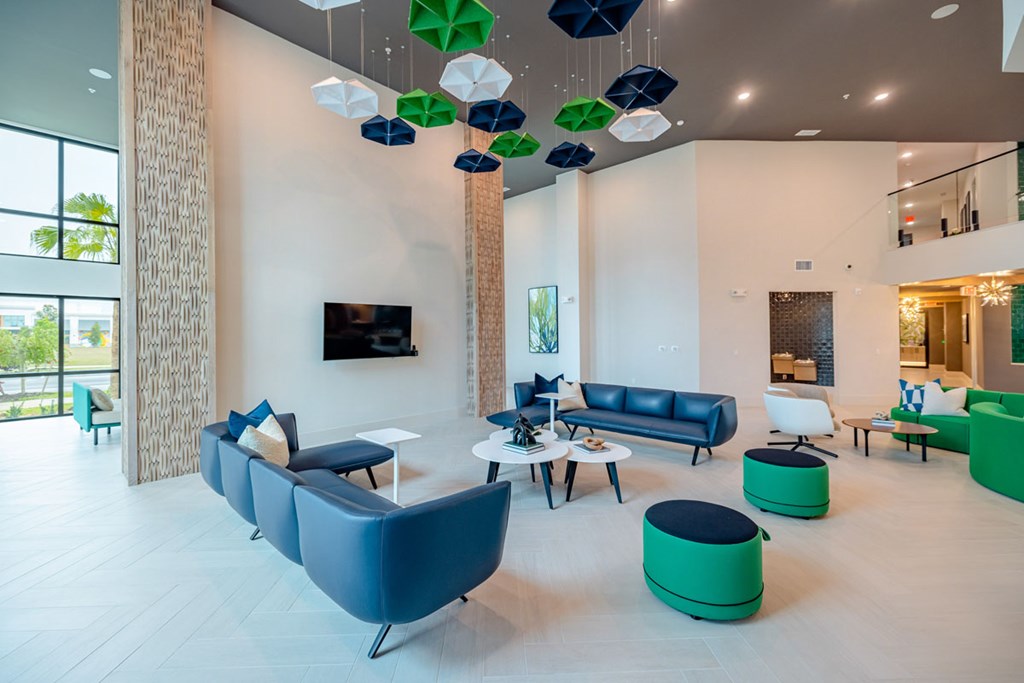 A modern living room with blue and green furniture.