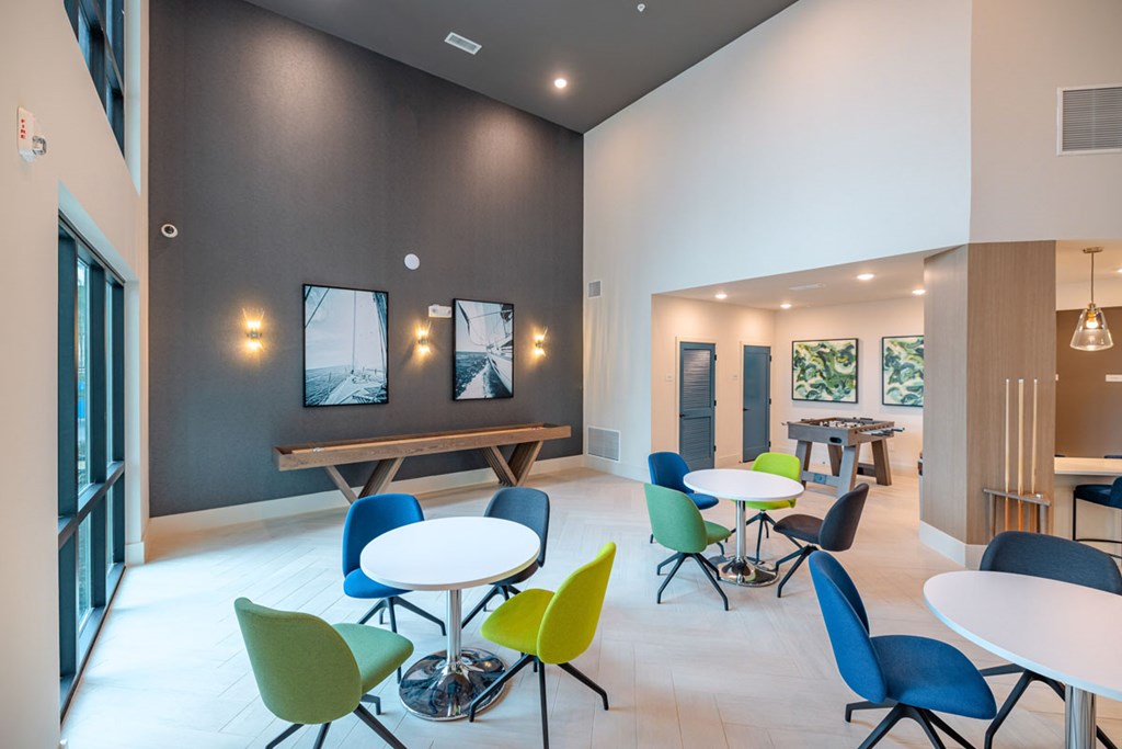 A room with tables and chairs and a bench.