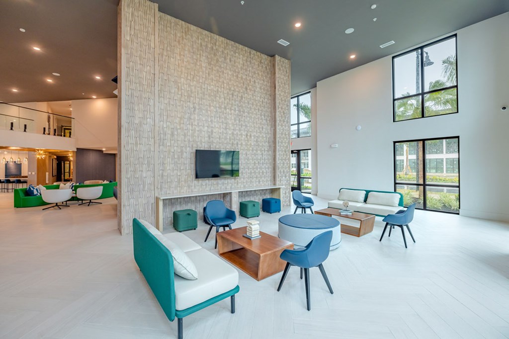 A modern living room with a television, sofas, and chairs.