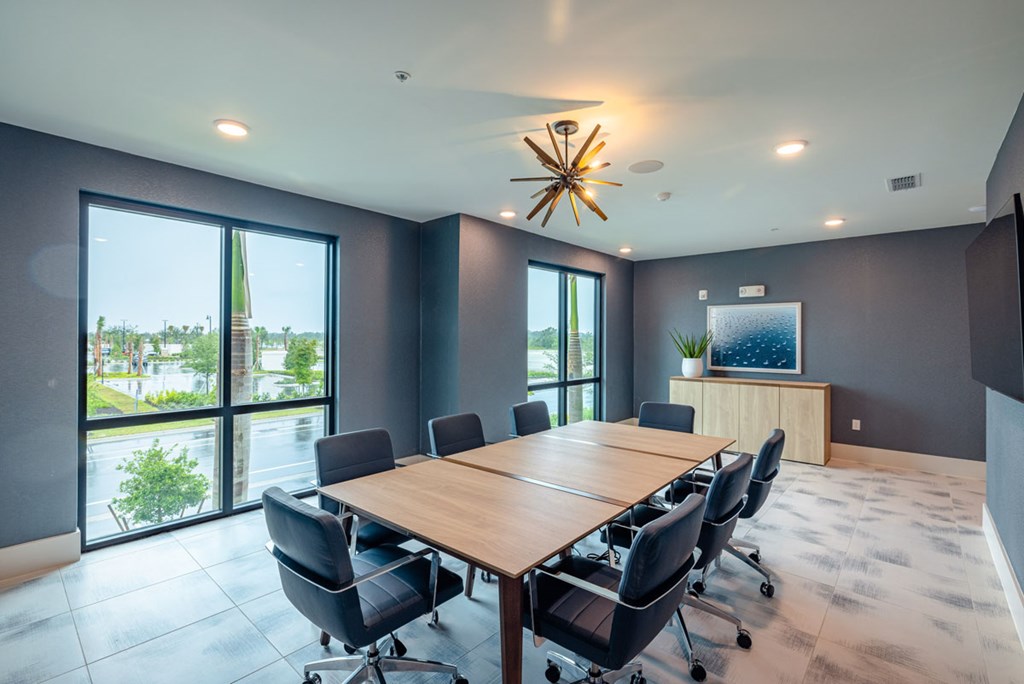 A conference room with a long table and chairs.