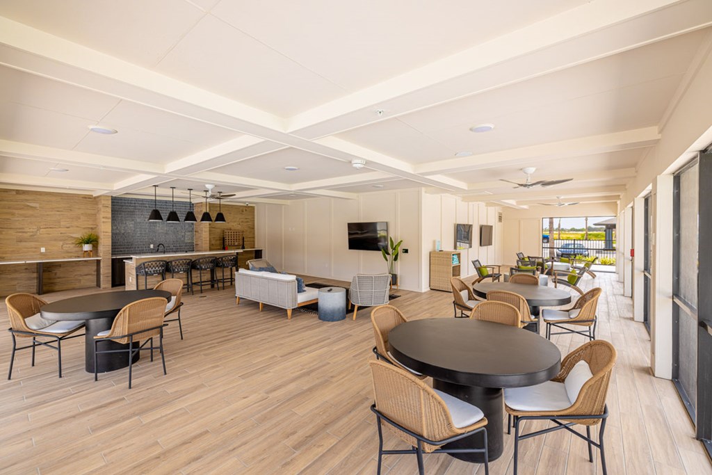 A modern dining room with a large table surrounded by chairs.