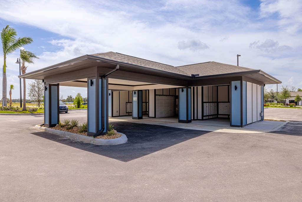 A building with a parking lot in front of it.