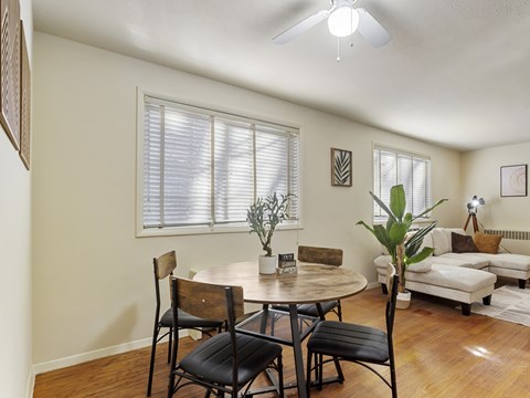 A dining room with a table and chairs.