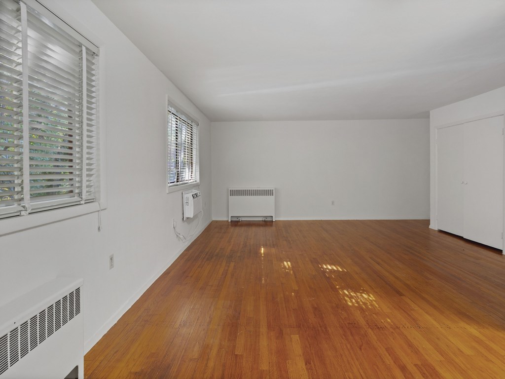 A room with wooden floors and white walls.