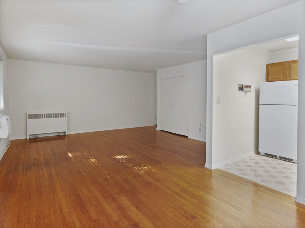 A room with wooden floors and white walls.