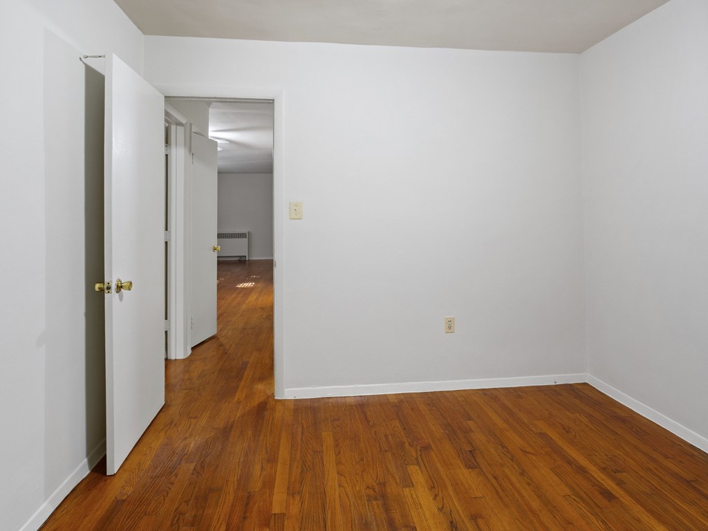A room with wooden floors and white walls.