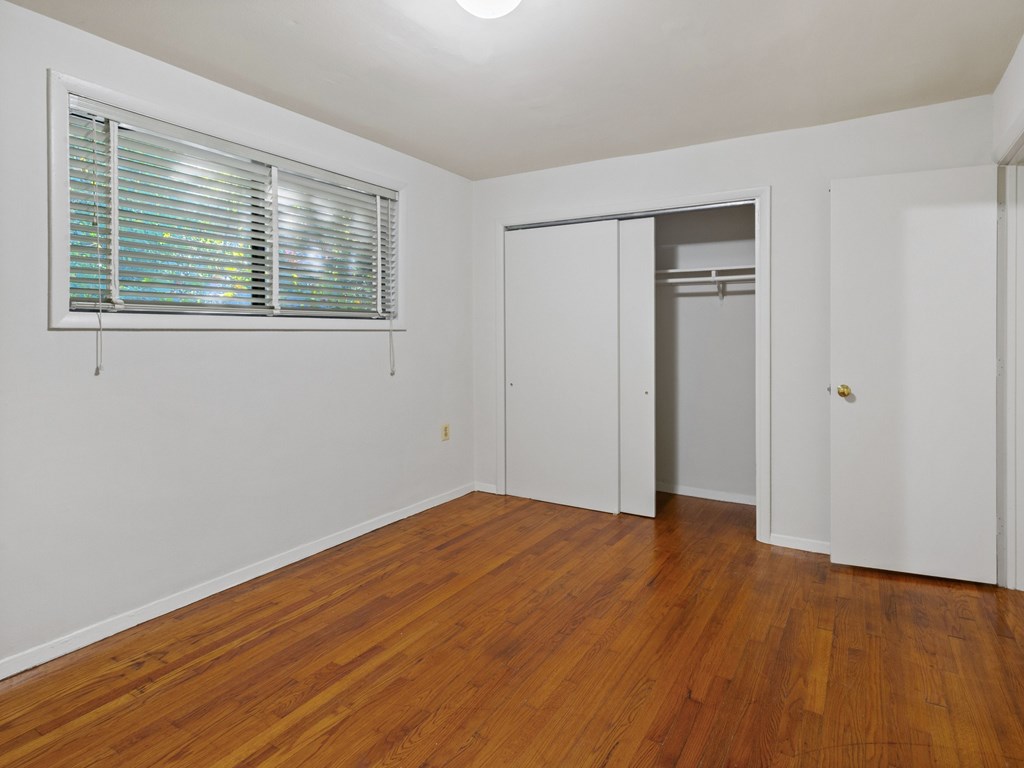 A room with wooden floors and white walls.
