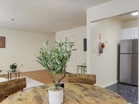 A living room with a wooden table and a plant on it.