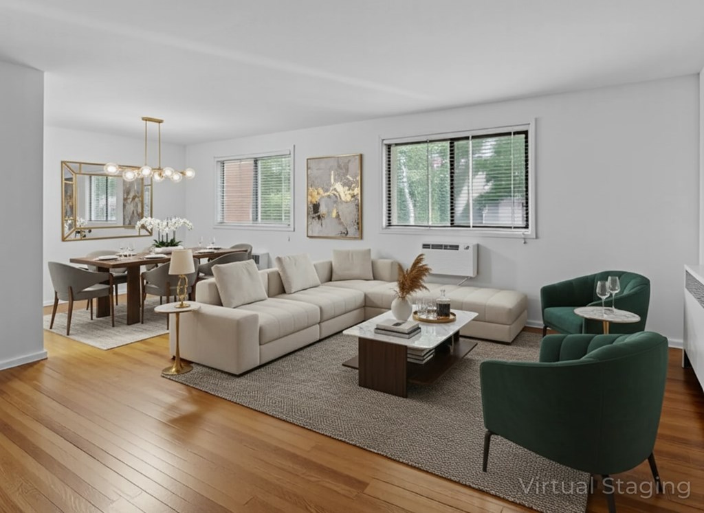 A living room with a white couch, a green armchair, and a coffee table.