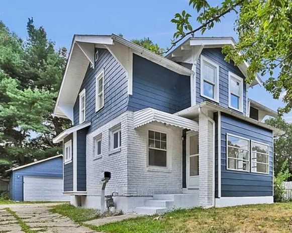 A blue house with white trim and a grey roof.