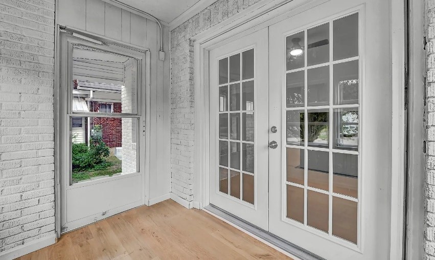 A white interior with a glass door and a window.